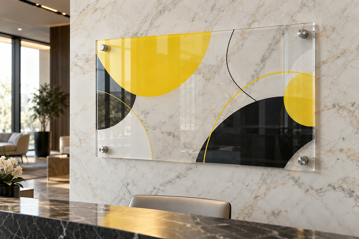 Clear acrylic sign with standoffs on a marble lobby wall